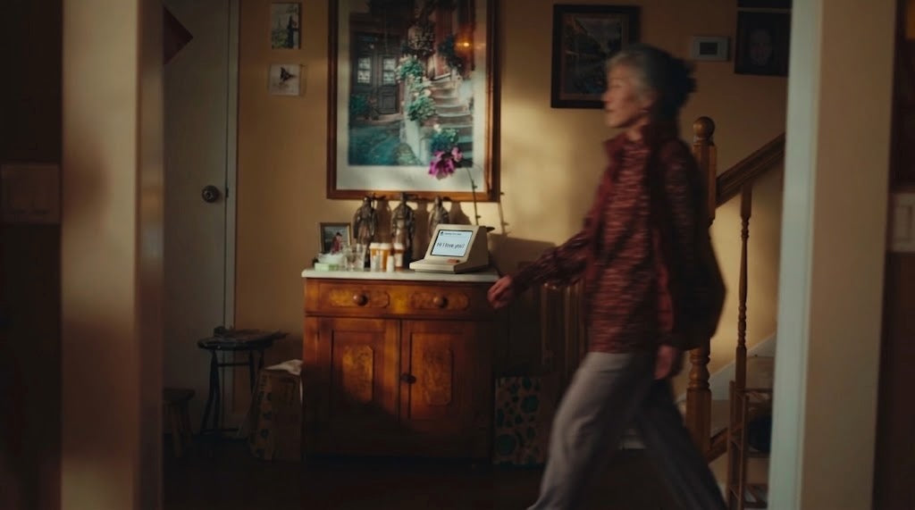 A Memobox on a hallway cabinet as someone walks past